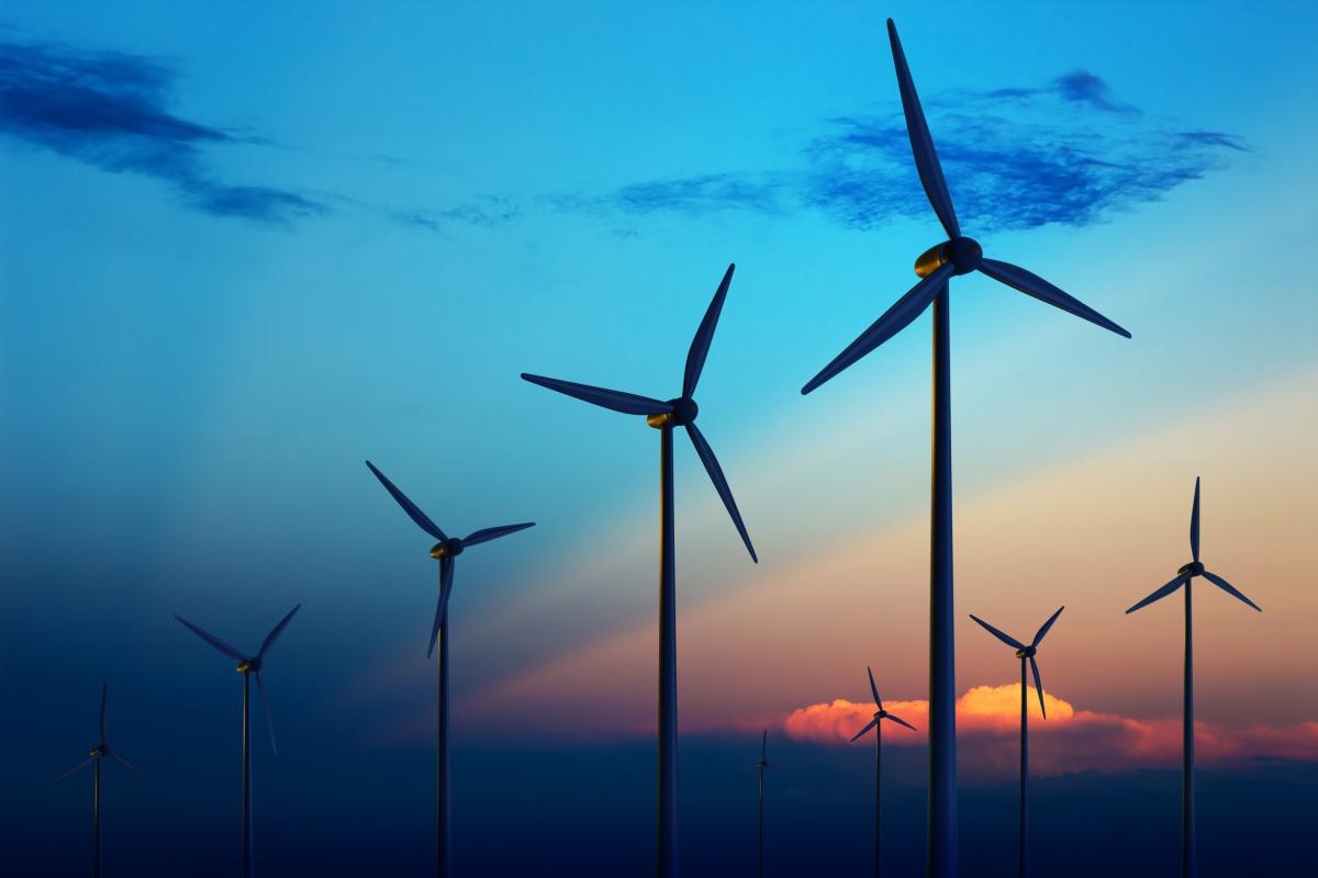 Wind turbine farm at sunset (stock photo)