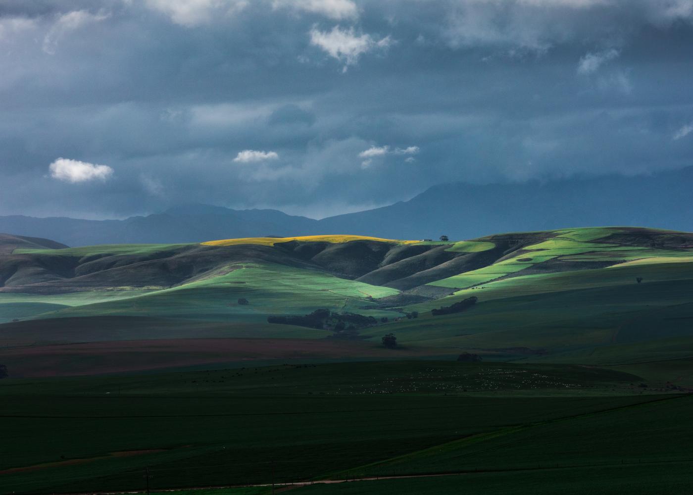 Green foothills against evening sky