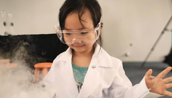 Photo showing young person working on a chemistry project