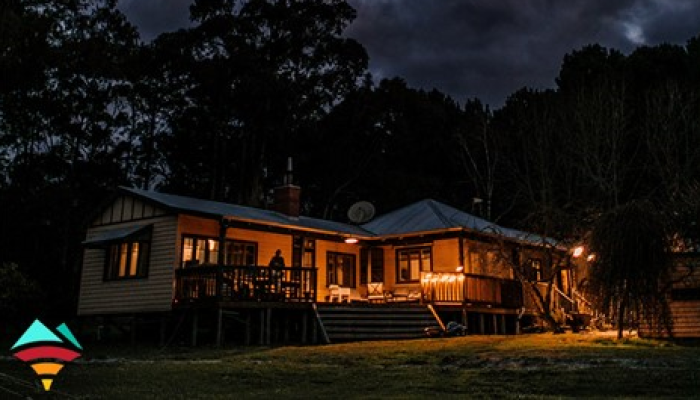 Photo of house at night with lights on