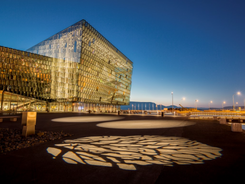 Harpa Conference Center Lit at Night with Shadow on Ground in Front